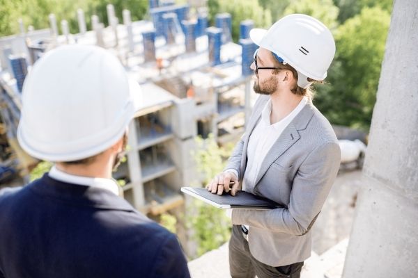 A private town planner briefing a client on site before a development application is lodged